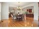 Bright dining area open to the kitchen and living room features hardwood floors and elegant chandelier at 1206 Mountainside Nw Trce, Kennesaw, GA 30152