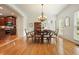 Bright dining area open to the kitchen features hardwood floors, white trim and view to backyard at 1206 Mountainside Nw Trce, Kennesaw, GA 30152