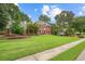 Beautiful single Gathering home with a perfectly manicured lawn, mature trees, and inviting curb appeal at 1206 Mountainside Nw Trce, Kennesaw, GA 30152