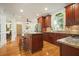 A gourmet kitchen features custom cabinetry, granite countertops, and stainless steel appliances at 1206 Mountainside Nw Trce, Kennesaw, GA 30152
