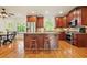 Well-appointed kitchen with wood cabinets, granite countertops, stainless steel appliances, and island seating at 1206 Mountainside Nw Trce, Kennesaw, GA 30152