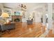 Open-concept living room with hardwood floors, fireplace, built-in shelves and view to dining room at 1206 Mountainside Nw Trce, Kennesaw, GA 30152