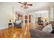 Open-concept living room with hardwood floors, fireplace, built-in shelves and view to dining room at 1206 Mountainside Nw Trce, Kennesaw, GA 30152