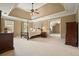 Spacious main bedroom with tray ceilings, a four-poster bed, and large windows at 1206 Mountainside Nw Trce, Kennesaw, GA 30152