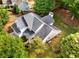 Aerial view of the home showcasing the roof, surrounding trees, well-maintained landscaping, and proximity to neighbors at 1607 Boulder Walk Se Dr, Atlanta, GA 30316