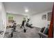 Basement gym featuring multiple machines, weights, a bench, and a grey couch for post-workout relaxation at 1607 Boulder Walk Se Dr, Atlanta, GA 30316