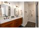 Modern bathroom features a double sink vanity, decorative mirrors, and eye-catching patterned flooring at 1607 Boulder Walk Se Dr, Atlanta, GA 30316