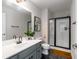 Updated bathroom featuring modern vanity with white countertop, framed mirror, toilet, and stand up glass shower at 1607 Boulder Walk Se Dr, Atlanta, GA 30316