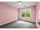 Bright bedroom with neutral carpet and pink walls at 1607 Boulder Walk Se Dr, Atlanta, GA 30316