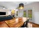 Open-concept dining area with a large wooden table, stylish pendant lighting, and a view into the living room at 1607 Boulder Walk Se Dr, Atlanta, GA 30316