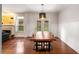 Bright dining area featuring hardwood floors, modern light fixture, and a large dining table, perfect for entertaining at 1607 Boulder Walk Se Dr, Atlanta, GA 30316