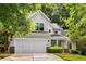 Charming two-story home featuring a well-manicured lawn, covered porch, and attached two-car garage at 1607 Boulder Walk Se Dr, Atlanta, GA 30316