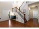 Inviting foyer with hardwood floors, staircase, and stylish green console table at 1607 Boulder Walk Se Dr, Atlanta, GA 30316