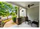 Inviting front porch with stone accents, ceiling fan, hanging plant, and seating, offers a comfortable outdoor space at 1607 Boulder Walk Se Dr, Atlanta, GA 30316