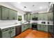 Bright kitchen with shaker cabinets, stainless steel appliances, white countertop, and beautiful hardwood floors at 1607 Boulder Walk Se Dr, Atlanta, GA 30316