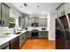 Well-lit kitchen with shaker cabinets, modern stainless steel appliances, white countertops, and warm hardwood floors at 1607 Boulder Walk Se Dr, Atlanta, GA 30316