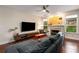 Comfortable living room featuring a fireplace, hardwood floors, a large sectional sofa, and ample natural light at 1607 Boulder Walk Se Dr, Atlanta, GA 30316