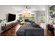 Bright living room featuring a fireplace, hardwood floors, a large sectional sofa, and ample natural light at 1607 Boulder Walk Se Dr, Atlanta, GA 30316