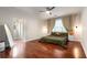 Comfortable main bedroom featuring hardwood floors, a ceiling fan, and natural light from the large window at 1607 Boulder Walk Se Dr, Atlanta, GA 30316