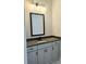 Bathroom vanity features gray cabinetry, a dark countertop, and a modern faucet fixture at 195 Silvercrest Dr, Acworth, GA 30101