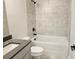 Clean bathroom featuring a sleek vanity with modern fixtures, a tub, and tiled walls at 195 Silvercrest Dr, Acworth, GA 30101