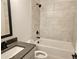 Stylish bathroom features a shower over tub, tiled walls and modern vanity at 195 Silvercrest Dr, Acworth, GA 30101