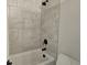 This bathroom features a tub with shower, gray-tiled walls, and black hardware at 195 Silvercrest Dr, Acworth, GA 30101