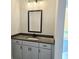 Bathroom vanity features gray cabinetry, a dark countertop, and a modern faucet fixture at 195 Silvercrest Dr, Acworth, GA 30101