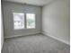 A bedroom featuring neutral walls, plush carpeting, and a window with backyard views at 195 Silvercrest Dr, Acworth, GA 30101