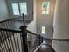View from staircase overlooking the entryway with hardwood floors and a stylish chandelier at 195 Silvercrest Dr, Acworth, GA 30101
