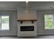 Bright living room features a modern fireplace with a rustic wooden mantel and an electric insert at 195 Silvercrest Dr, Acworth, GA 30101