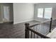 Open loft area with wood floors, views of the neighborhood, and a glimpse into an adjacent bedroom at 195 Silvercrest Dr, Acworth, GA 30101