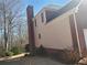View of the back exterior with brick and siding near treeline at 4217 Mill Grove Sw Ln, Smyrna, GA 30082