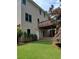 Back of house with wooden deck and stairs, complemented by lush green lawn at 4217 Mill Grove Sw Ln, Smyrna, GA 30082