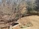 View of wooded backyard and a stone terrace at 4217 Mill Grove Sw Ln, Smyrna, GA 30082