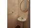 Powder room featuring a pedestal sink, oval mirror with gold frame, and neutral wall color at 4217 Mill Grove Sw Ln, Smyrna, GA 30082