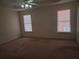 Bedroom with two windows, neutral carpet, ceiling fan, and natural light at 4217 Mill Grove Sw Ln, Smyrna, GA 30082