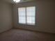 A carpeted bedroom features a double window and neutral paint at 4217 Mill Grove Sw Ln, Smyrna, GA 30082