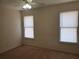 Bedroom features carpeted floors and natural lighting from two windows at 4217 Mill Grove Sw Ln, Smyrna, GA 30082