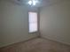 A carpeted bedroom features a single window and neutral paint at 4217 Mill Grove Sw Ln, Smyrna, GA 30082