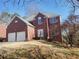 Charming two-story brick home with a manicured lawn and a two-car garage at 4217 Mill Grove Sw Ln, Smyrna, GA 30082