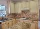 Charming kitchen featuring granite countertops, white appliances, and ample cabinet space at 4217 Mill Grove Sw Ln, Smyrna, GA 30082