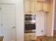 Bright kitchen features stainless steel double ovens and classic cream-colored cabinetry at 4217 Mill Grove Sw Ln, Smyrna, GA 30082