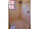 Small laundry room with tile floor, overhead shelf, and window for natural light at 4217 Mill Grove Sw Ln, Smyrna, GA 30082