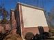A partial view of the side exterior with brick and siding at 4217 Mill Grove Sw Ln, Smyrna, GA 30082