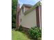 Home's siding and brick exterior with a tall chimney and verdant landscaping at 4217 Mill Grove Sw Ln, Smyrna, GA 30082