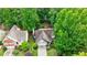 Aerial view of a home with mature trees and well-maintained landscaping at 8895 Club River Dr, Roswell, GA 30076