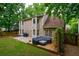 A backyard featuring a stone patio and a wooden deck, perfect for entertaining and relaxation at 8895 Club River Dr, Roswell, GA 30076