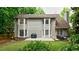 Exterior backyard view highlighting the patio and deck with grill and hot tub surrounded by lush green foliage at 8895 Club River Dr, Roswell, GA 30076