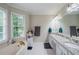 Relaxing bathroom featuring a soaking tub, double sink vanity and ample natural light at 8895 Club River Dr, Roswell, GA 30076